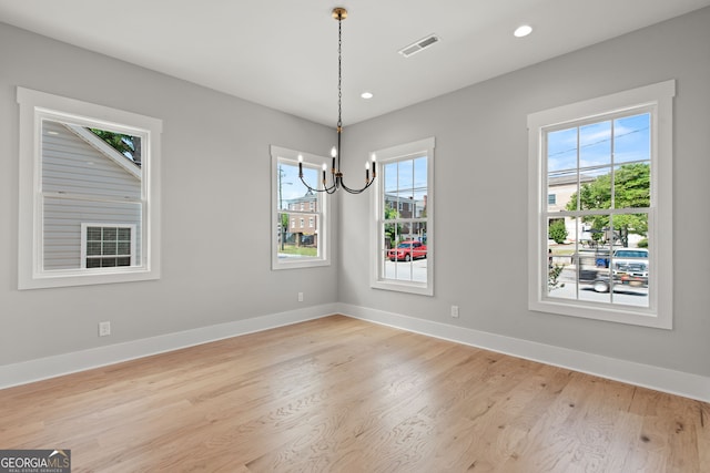 unfurnished dining area featuring light wood-type flooring, visible vents, baseboards, and recessed lighting