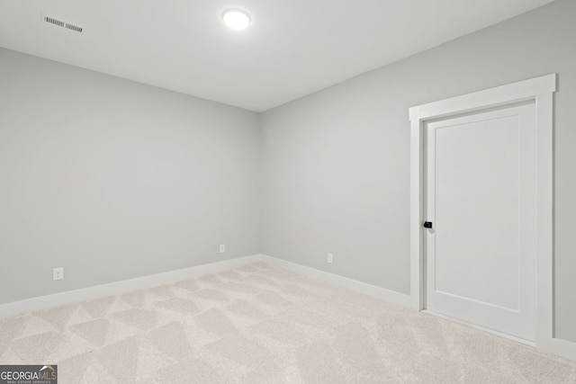 unfurnished room featuring baseboards, visible vents, and carpet flooring