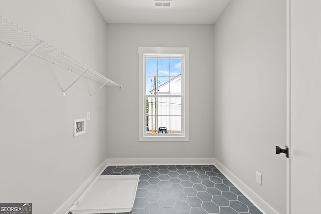 laundry room featuring hookup for a washing machine, laundry area, dark tile patterned flooring, visible vents, and baseboards