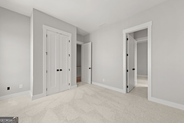 unfurnished bedroom featuring carpet, visible vents, and baseboards