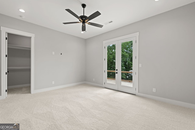 unfurnished room featuring carpet floors, baseboards, visible vents, and french doors