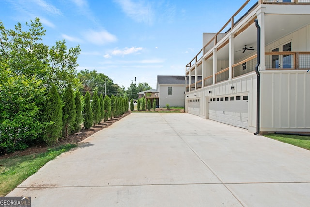 view of home's exterior with a ceiling fan, board and batten siding, and concrete driveway