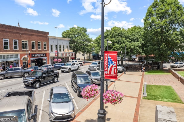 view of road featuring street lighting, curbs, and sidewalks