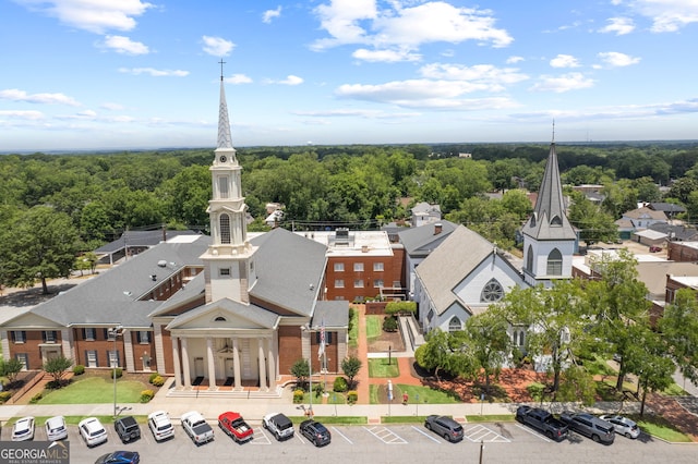 drone / aerial view featuring a residential view and a view of trees