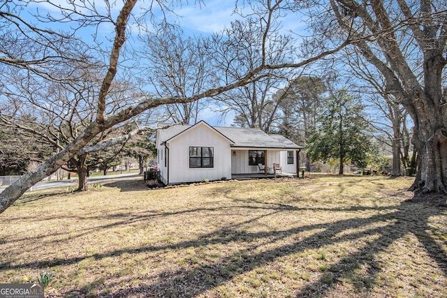 view of front of home with board and batten siding and a front yard