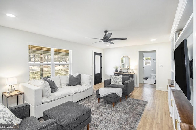 living room featuring ceiling fan, recessed lighting, light wood-style flooring, and a healthy amount of sunlight