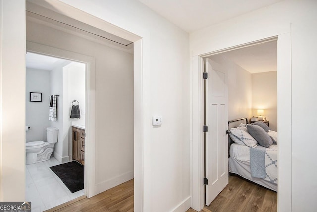 hallway with light wood-style flooring and baseboards