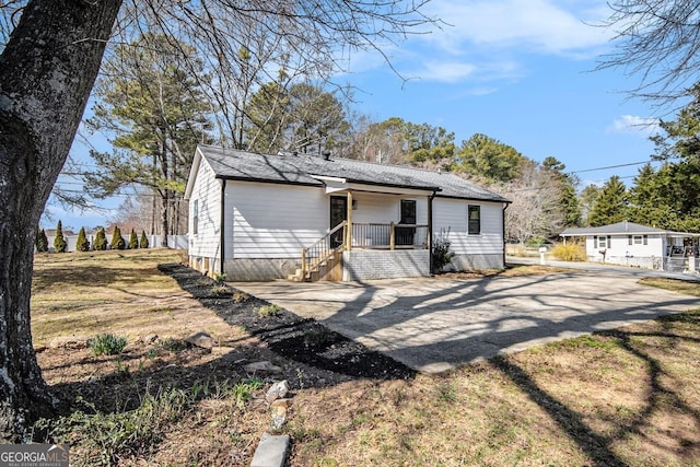 rear view of house with covered porch and driveway