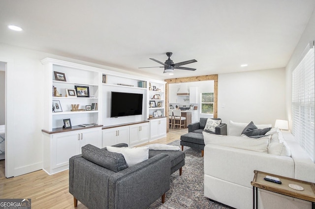 living area with a ceiling fan, light wood-type flooring, baseboards, and recessed lighting