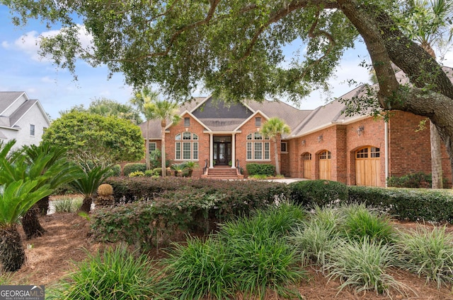 view of front of house with a garage and brick siding