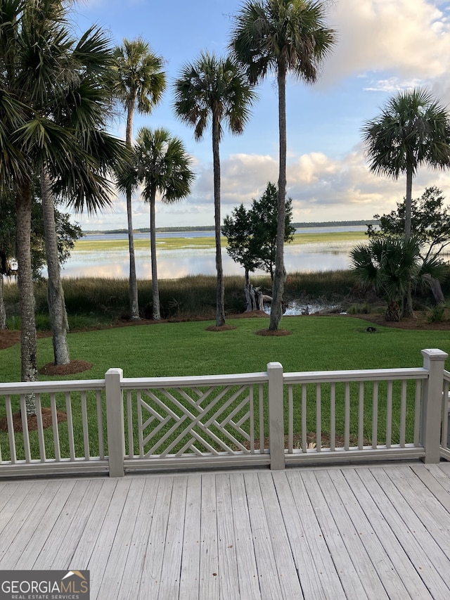 deck featuring a yard and a water view