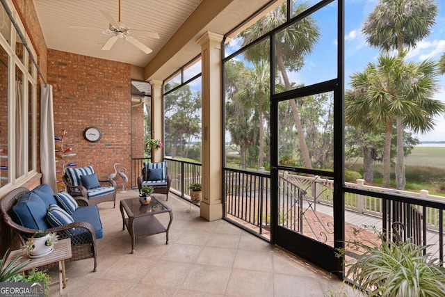 sunroom / solarium featuring ceiling fan and a healthy amount of sunlight