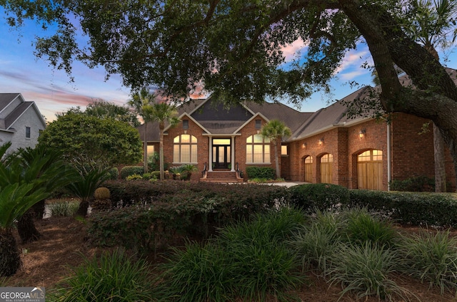 view of front of house featuring a garage and brick siding