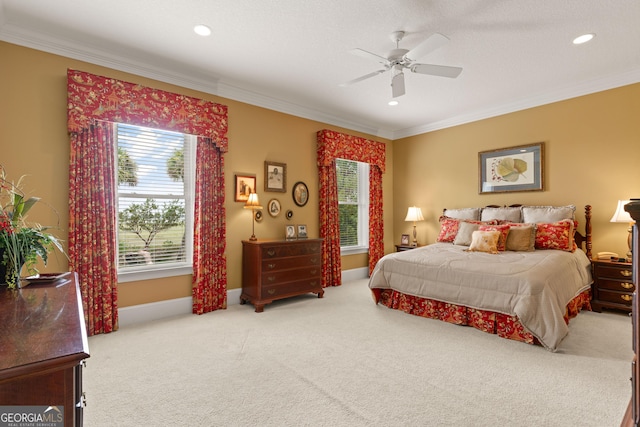 carpeted bedroom featuring baseboards, ornamental molding, ceiling fan, and recessed lighting