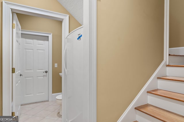 stairway with tile patterned flooring