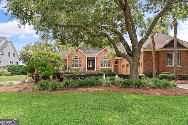 view of front of property featuring a front yard and brick siding