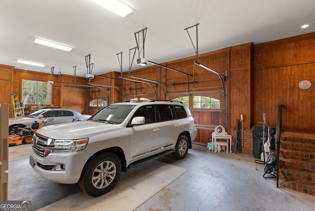 garage featuring wood walls and a garage door opener