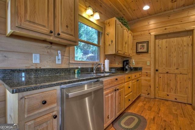 kitchen featuring wood ceiling, dark stone countertops, light wood-type flooring, stainless steel dishwasher, and a sink