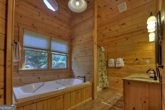 full bathroom with visible vents, wooden walls, a whirlpool tub, and vanity