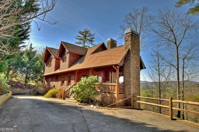 view of property exterior featuring a shingled roof and a chimney