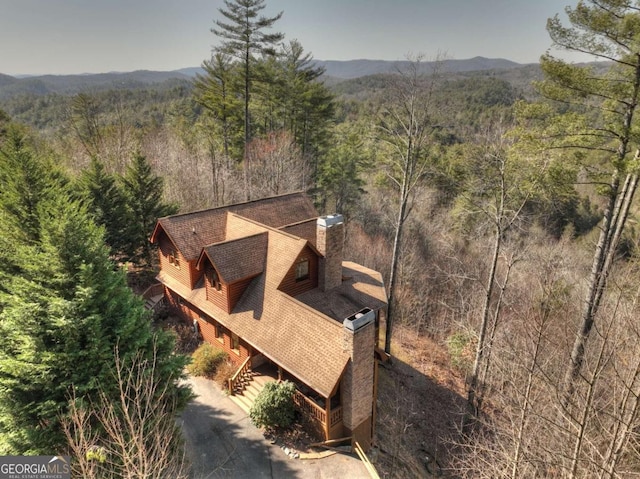 drone / aerial view featuring a mountain view and a forest view