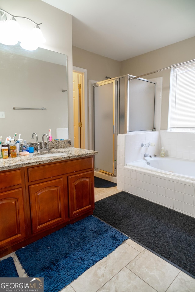 bathroom featuring a bath, a stall shower, and vanity