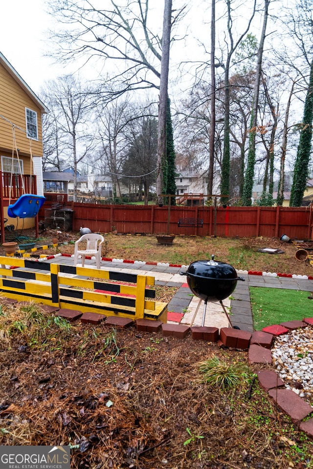 view of yard featuring a fire pit and fence