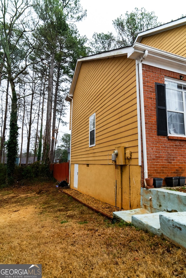 view of side of home featuring brick siding