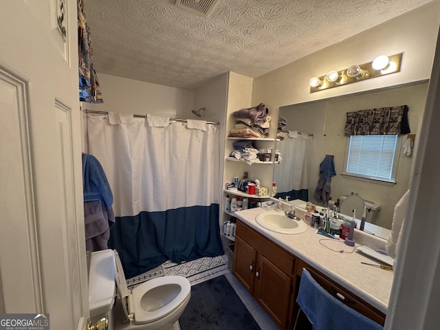 bathroom with visible vents, toilet, a shower with curtain, a textured ceiling, and vanity