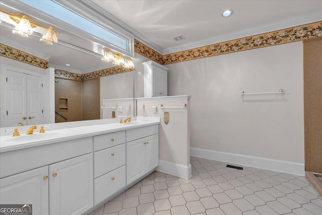 full bath featuring double vanity, ornamental molding, a sink, and baseboards