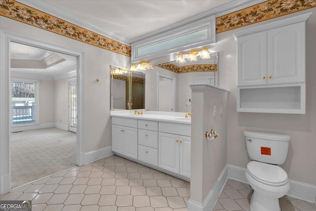 bathroom featuring double vanity, baseboards, toilet, ornamental molding, and a sink