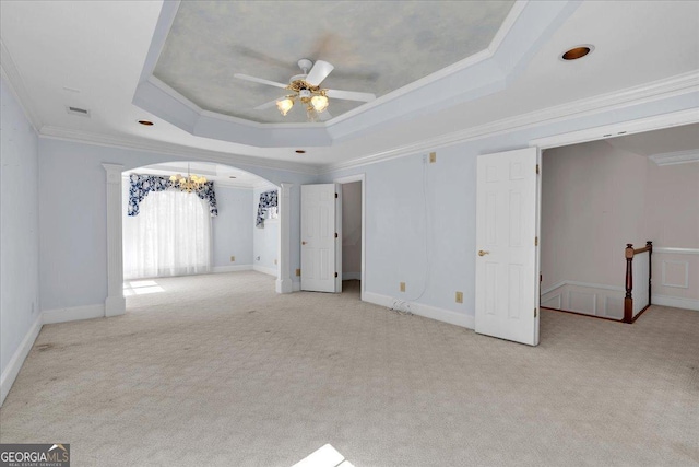 interior space with carpet floors, arched walkways, a raised ceiling, and ornamental molding