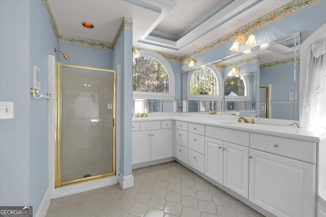 bathroom with a tray ceiling, ornamental molding, a stall shower, and vanity