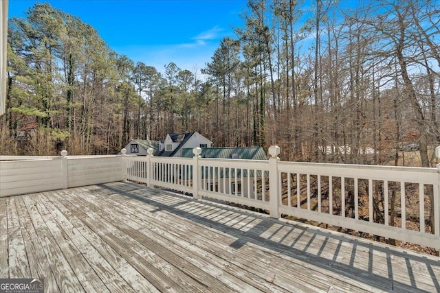 wooden terrace featuring an outdoor structure