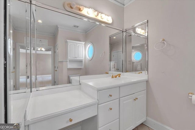 bathroom with ornamental molding, visible vents, vanity, and baseboards