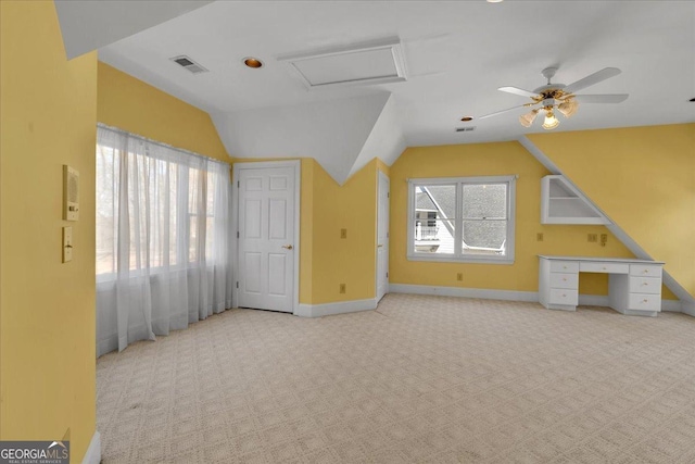 additional living space featuring carpet floors, baseboards, visible vents, and vaulted ceiling