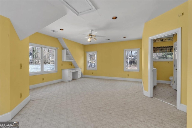 unfurnished living room with carpet, visible vents, and baseboards