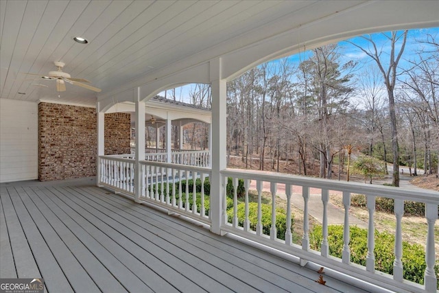 wooden terrace featuring ceiling fan