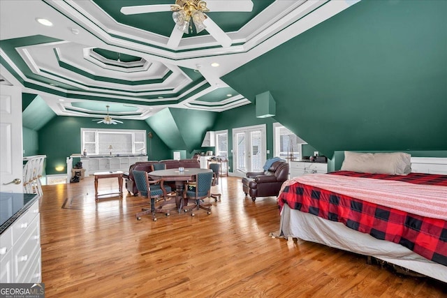 bedroom with ornamental molding and wood finished floors