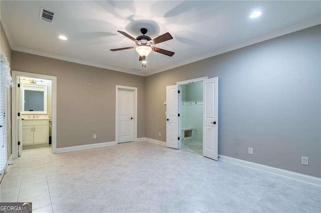 unfurnished bedroom featuring baseboards, ensuite bath, visible vents, and crown molding