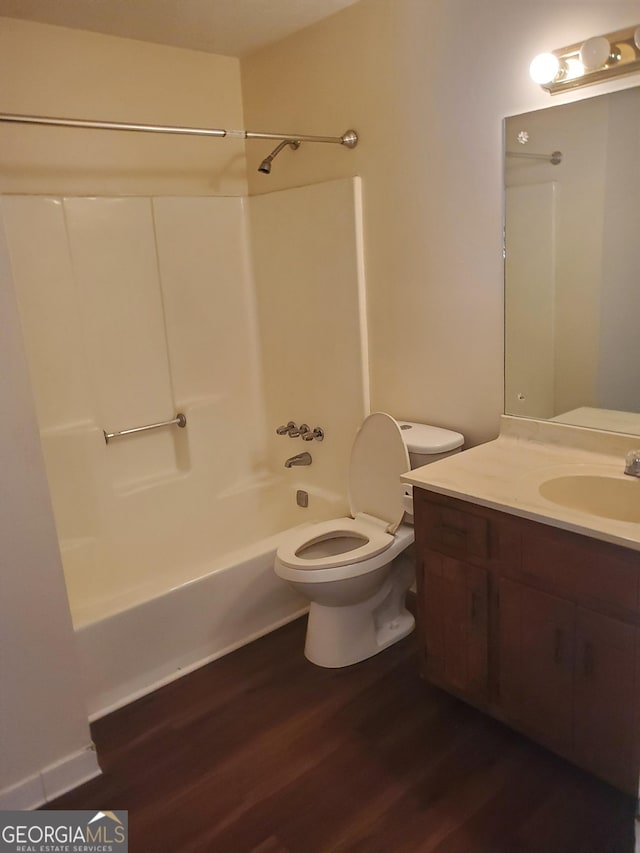 bathroom with  shower combination, vanity, toilet, and wood finished floors