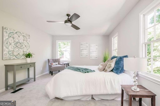 bedroom with visible vents, baseboards, carpet, and a ceiling fan