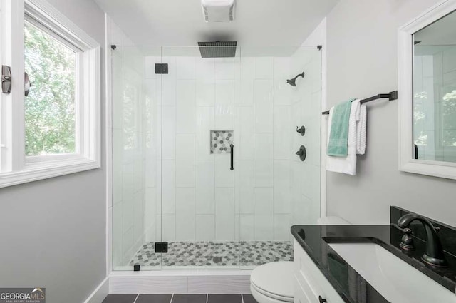 full bath featuring vanity, toilet, and a shower stall