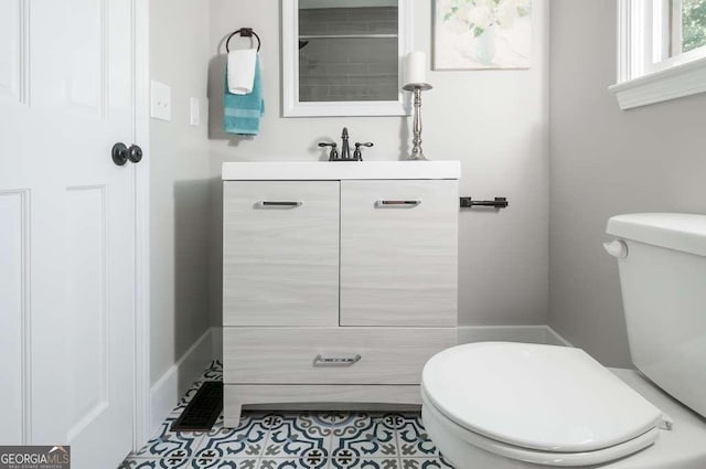 bathroom featuring tile patterned floors, toilet, and vanity