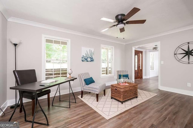 sitting room featuring a ceiling fan, crown molding, wood finished floors, and baseboards