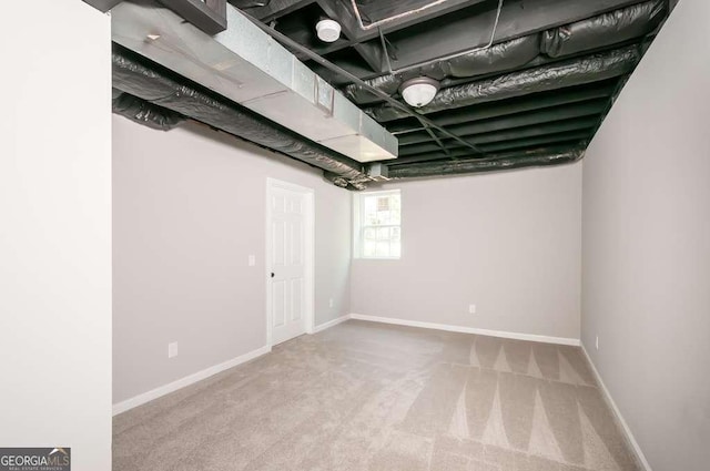 below grade area featuring baseboards and carpet floors