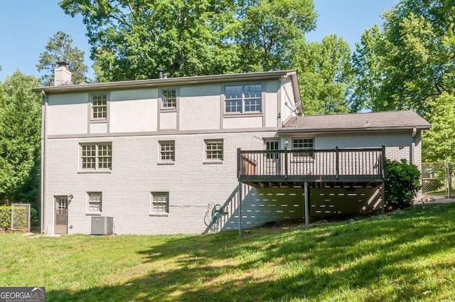 back of house featuring a wooden deck, cooling unit, a chimney, and a yard