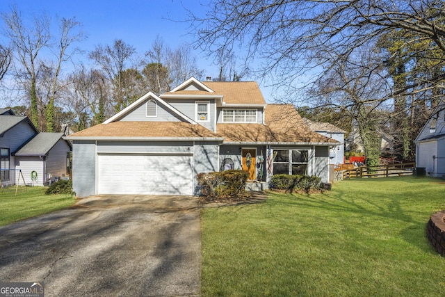 view of front of home with a garage, aphalt driveway, fence, a front yard, and brick siding