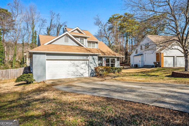 view of front of house with driveway, an attached garage, fence, a front lawn, and brick siding