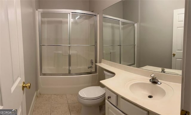 full bath with baseboards, toilet, enclosed tub / shower combo, tile patterned floors, and vanity